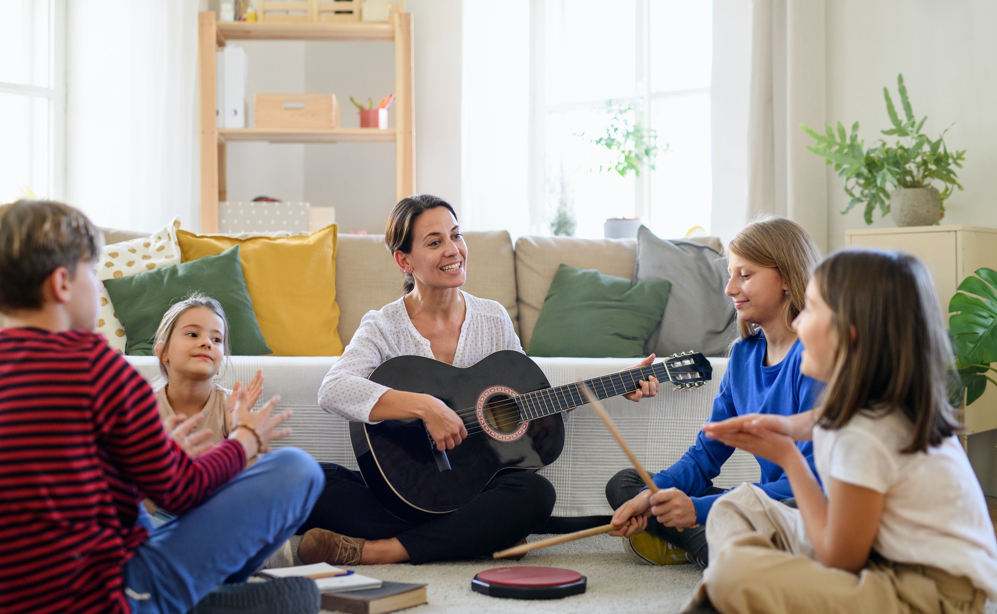 group-of-homeschooling-children-with-teacher-having-music-lesson-indoors-coronavirus-concept-1-1.jpg